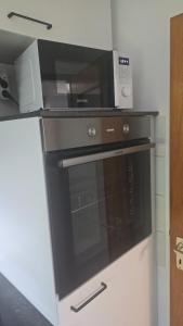 a microwave sitting on top of a kitchen oven at InnJoy! in Friedrichshafen +8 photos