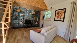 a living room with a couch and a fireplace at Ty ar C'hoad in Sulniac