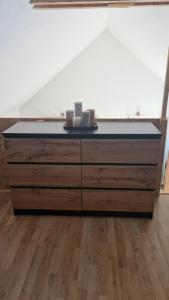 a dresser with two candles on top of it at Ty ar C'hoad in Sulniac
