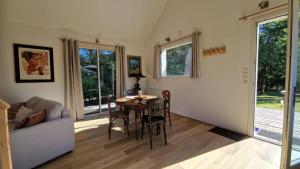 a living room with a table and a couch at Ty ar C'hoad in Sulniac