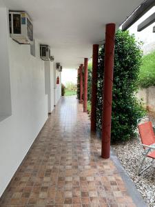 a hallway of a house with a red chair at Hostería Boulevard in Villa María