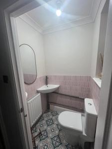 a small bathroom with a toilet and a sink at Gravesend Central - Spacious & Quiet Rooms in Gravesend