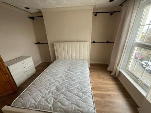 a bedroom with a bed and a window at Gravesend Central - Spacious & Quiet Rooms in Gravesend