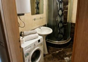 a bathroom with a washing machine and a sink at Apartmani Anja in Ohrid +7 photos