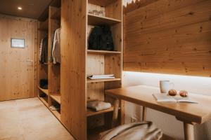a wooden room with a wooden table and shelves at Landhaus Albert Murr inkl Premium Sommerkarte in Sankt Anton am Arlberg