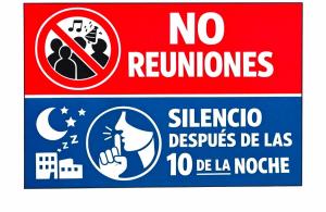 a red sign with a no rezoning sign and no returnriors sign at Como en Familia in Esquipulas