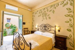 a bedroom with a bed in a room with a window at Tenuta Masseria del Gallo in Calimera