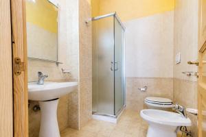 a bathroom with a sink and a toilet and a shower at Tenuta Masseria del Gallo in Calimera +23 photos