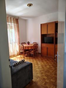 a living room with a table and a dining room at la casa rosa in Breguzzo