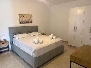 a bedroom with a bed with white sheets and pillows at Sea La Vie in Nikiana +27 photos