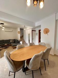 a living room with a wooden table and chairs at Sea La Vie in Nikiana