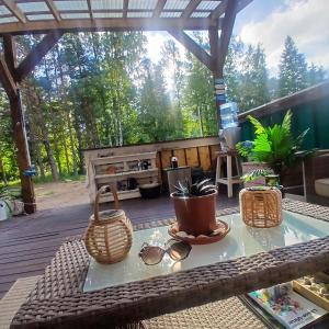 a table withsunglasses and glasses on a patio at Miami Jungle Glamping Experience in Korjuse +35 photos