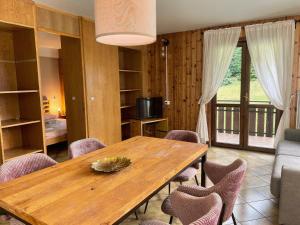 a dining room with a wooden table and chairs at Residence Rododendro in Passo San Pellegrino