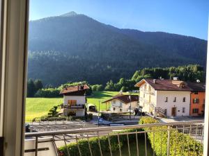 a view from a window of a town with a mountain at la casa rosa in Breguzzo