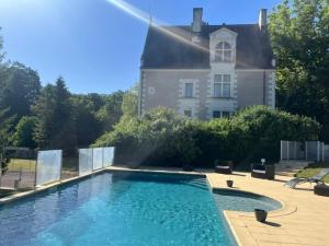 a swimming pool in front of a large house at  