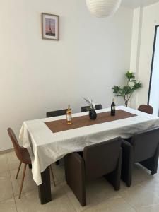 a dining room table with two bottles of whisky on it at MAISON 4 CHAMBRES et 4 GRANDS LITS in Liège +17 photos