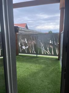 a view from the window of a balcony with green grass at apartmany agnieszka in Smižany