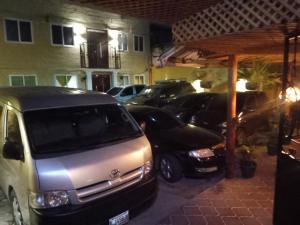 a group of cars parked in a parking lot at Hotel Fontana Real in Quetzaltenango