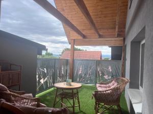 a patio with a table and chairs and a balcony at apartmany agnieszka in Smižany
