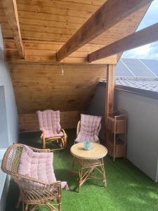 a patio with chairs and a table and a roof at apartmany agnieszka in Smižany