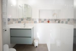 a white bathroom with a sink and a mirror at Le refuge à la campagne in Toulonjac +28 photos