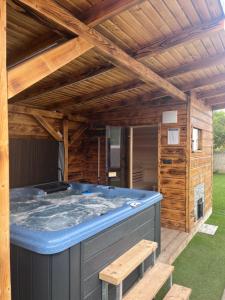 a hot tub in a backyard with a wooden roof at apartmany agnieszka in Smižany