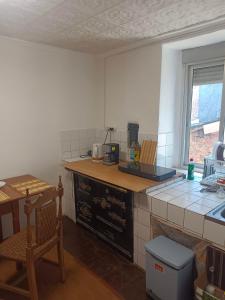 a kitchen with a counter and a table and a chair at casa SARMA in Las Médulas