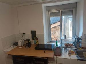 a kitchen with a counter top with a window at casa SARMA in Las Médulas +8 photos