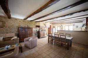a living room with a table and chairs at Le refuge à la campagne in Toulonjac