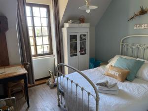 a bedroom with a bed and a window at Bienvenue chez Chris ! in Saint-Hilaire-des-Landes +23 photos