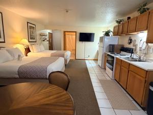 a small hotel room with two beds and a kitchen at Whitetail Creek Resort in Lead