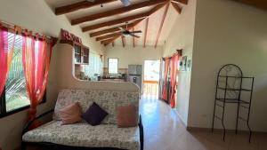 a living room with a couch and a kitchen at The Inner Light Yoga Lodge in Sámara