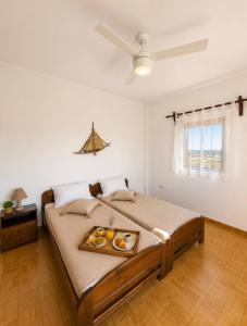 a bedroom with a bed with a tray of donuts on it at Casa di Ricci Paros in Dhragoulás