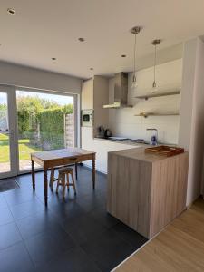 a kitchen with a wooden table and a wooden counter at De 50 Steenbrugge in Oostkamp