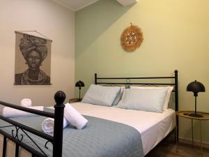 a bedroom with a bed and a picture on the wall at Lemon Tree Apartment in Chios