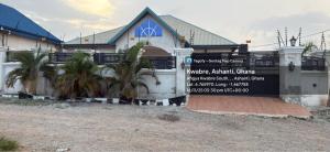 a house with a sign in front of it at Mavis Lodge in Janman +4 photos