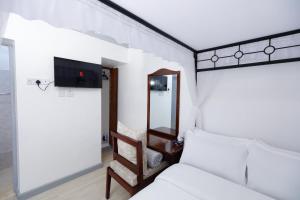 a bedroom with a bed and a mirror at Self Contained Studio in Nakuru