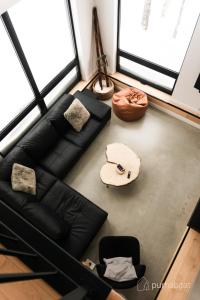 a living room with a couch and a surfboard on the floor at Pur Nature et Spa Eastman in Eastman