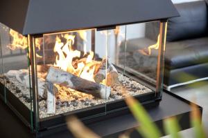 a fireplace with fire in it on a table at Pur Nature et Spa Eastman in Eastman