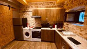 a small kitchen with a stove and a washer at Casa Stratigos in Corfu +87 photos