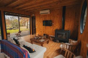 a living room with a couch and a fireplace at Cozy Premium Delta Cabin Private Dock in Tigre