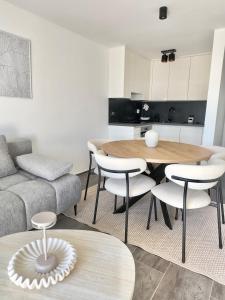 a living room with a table and chairs and a couch at Romantic 3 Bedroom Apartment 3min from the beach in Kruševo