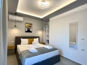 a bedroom with a bed with towels on it at Mimoza Apartments in Limenaria