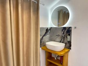a bathroom with a sink and a mirror at Mimoza Apartments in Limenaria +40 photos