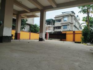 an empty parking lot with a building in the background at Pure Bliss 3BHK Stay in Guwahati