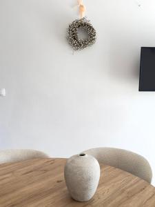 a table with two chairs and a wreath on the wall at Romantic 3 Bedroom Apartment 3min from the beach in Kruševo