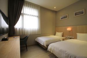 Postel nebo postele na pokoji v ubytování Hangkhau Hotel
