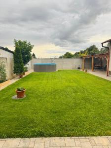 a large lawn with a pool in the middle at Apartmány Bozen Lednice in Lednice