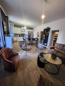 a living room with a couch and chairs and a table at Madras in Sète