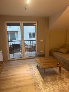 a living room with a couch and a coffee table at Premium Rooms in Struga